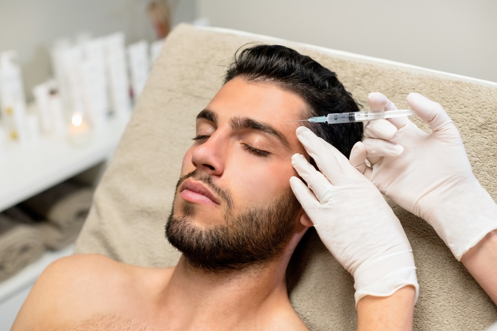 Shanni Sutton administering Xeomin injection to a man