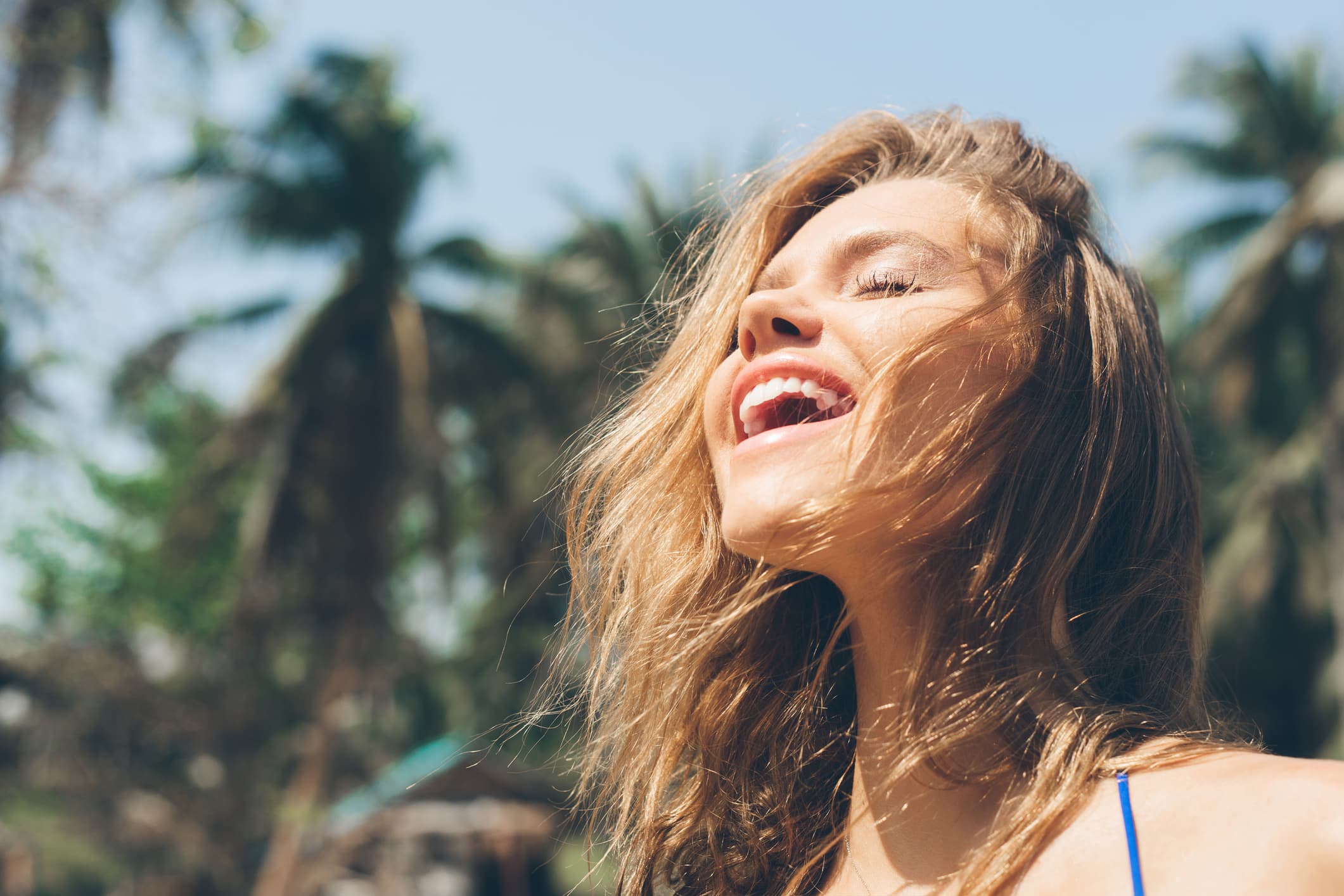 Woman enjoying sunlight, related to sun damage awareness.