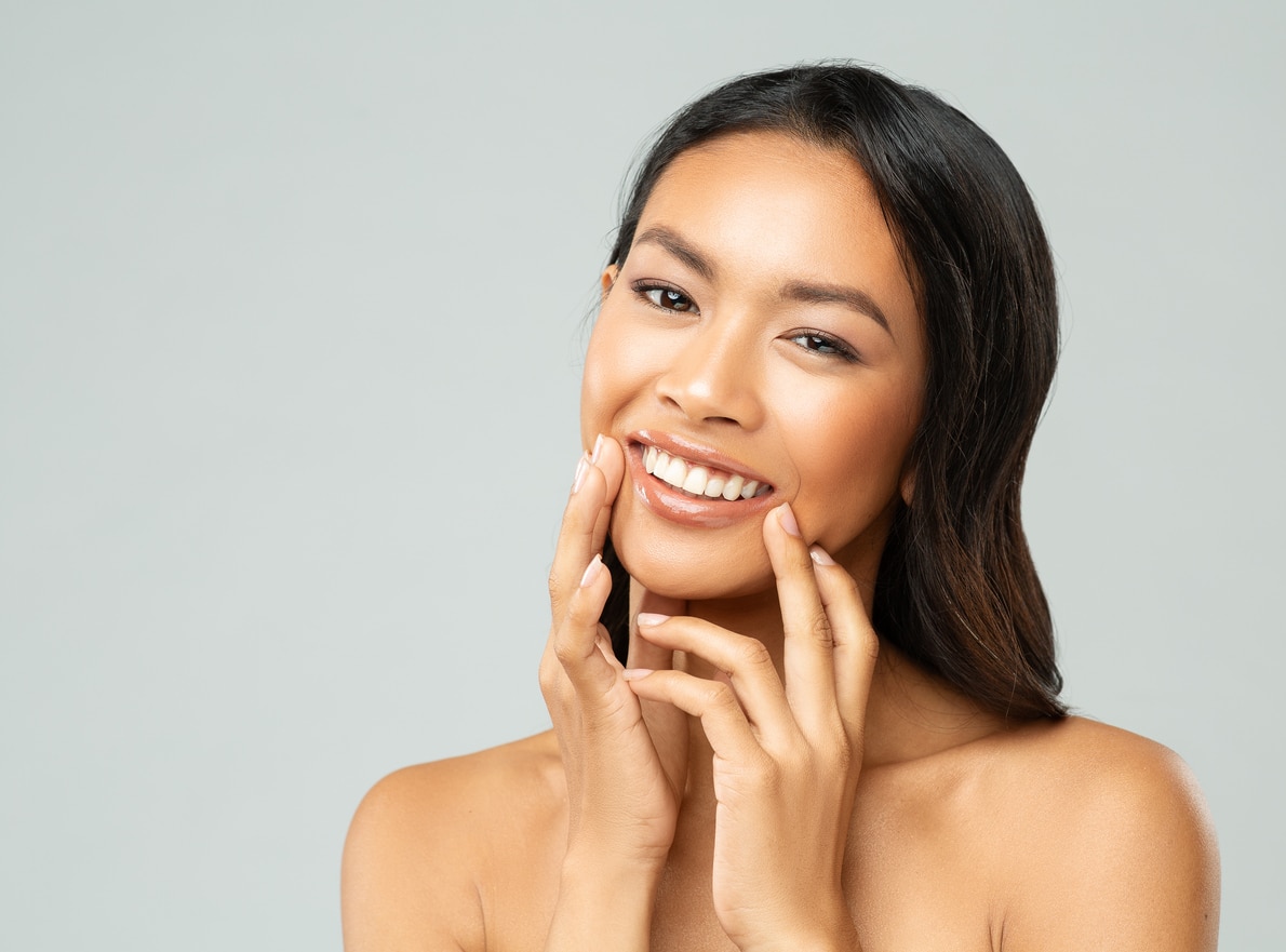 Smiling woman with smooth skin, showcasing JUVÉDERM results.